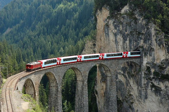 The Bernina Express is a famous Swiss train route through high alpine regions, with spiralling sections of track, hairpin turns, breathtaking views of waterfalls and mountains.