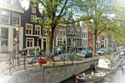 Old houses by canal in Amsterdam